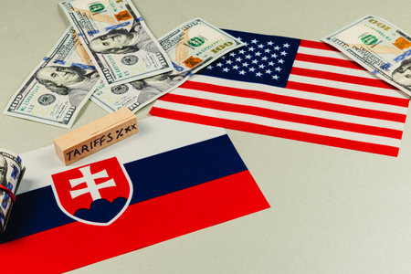 Money, flags, and tariff blocks symbolize the tense negotiations over trade policies between the USA and Slovakia amidst ongoing global political tensions.の写真素材