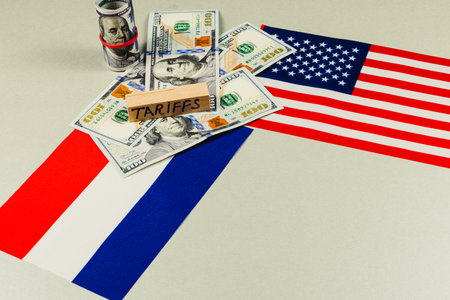Currency notes surround flags of France and the USA, highlighting themes of trade, tariffs, and the complexities of international politics and economy.の写真素材