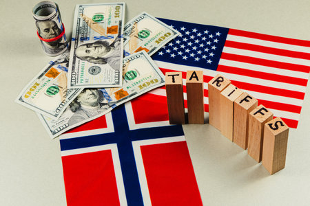 Currency notes representing financial dealings are arranged near flags of the USA and Norway, highlighting tariff discussions and trade tensions in current politics.の写真素材