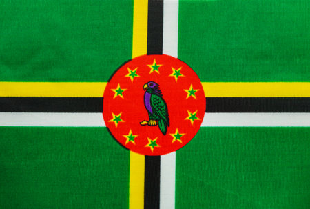 Brightly colored national flag of Dominica features a parrot at the center. It showcases green,...