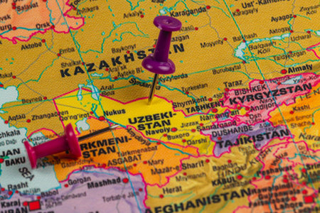 A colorful map displays Uzbekistan and surrounding countries, with push pins marking key cities. The region's geography is highlighted for exploration.の写真素材