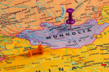 Orange and purple pushpins are placed on a map highlighting Mongolia's capital and the Gobi Desert, showcasing geographical features and locations.の写真素材