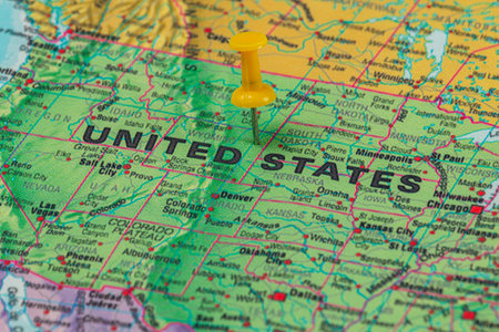 A detailed map showing the United States with a bright yellow pushpin marking a specific location, highlighting geography and cartography.の写真素材