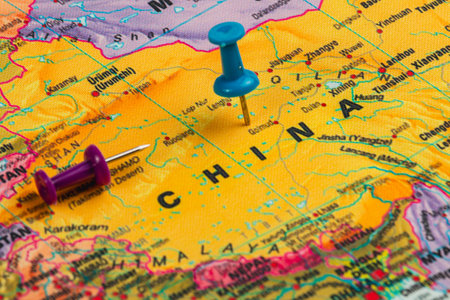 Colorful map features China with two push pins indicating potential travel locations. The map shows...