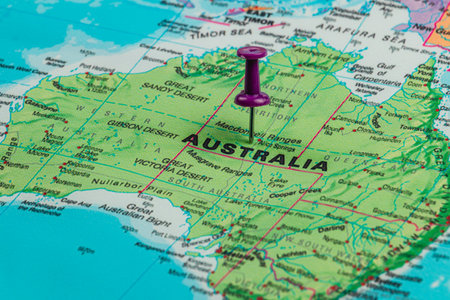 A detailed map showcases Australia, highlighting geographical features with a purple pin marking a specific area. Surrounding regions and cities are also visible.の写真素材