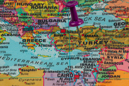 A purple pushpin marks the location of Turkey on a detailed map showing countries in Europe and Asia, highlighting geographical features and borders.の写真素材