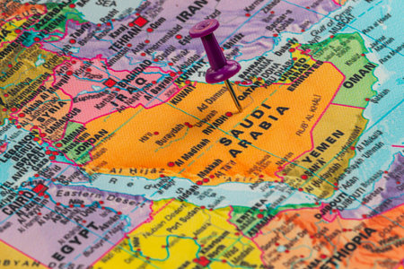 A colorful map displays Saudi Arabia, highlighted with a pushpin, showcasing the geography and neighboring countries within the Middle Eastern region.の写真素材