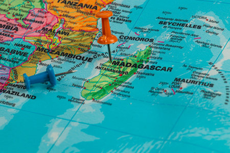 Colorful pushpins indicate locations on a map of Madagascar and surrounding areas. This map shows key geographical features and nearby islands clearly.の写真素材