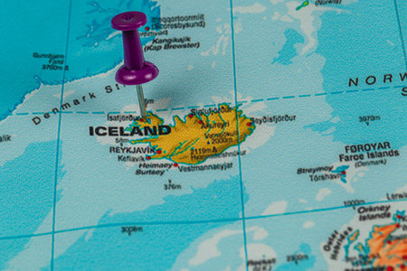 A map focuses on Iceland, highlighting Reykjavik with a purple pushpin, emphasizing the island's geographical location in the North Atlantic.の写真素材