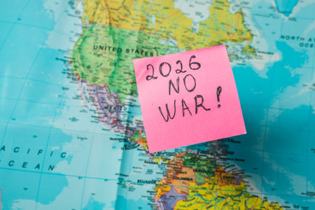 Lviv Ukraine 11.28.25 A bright sticky note reads 2026 no war, placed on a colorful world map. The...