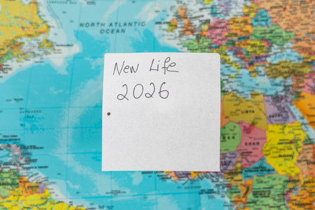 Lviv Ukraine 11.28.25 A world map displays various countries and oceans with a note that reads 'New Life 2026.' This scene suggests future travel and exploration plans.の写真素材