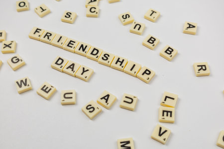 People gather to enjoy National Scrabble Day by playing the game. Letters are placed on a board to...