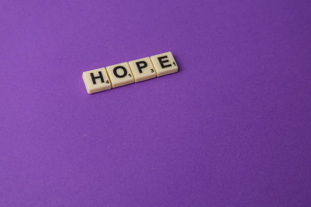 Lviv Ukraine 02.26.26 Scrabble tiles placed on a purple background spell the word hope, showing the joy of playing games on National Scrabble Day with friends and family.のeditorial素材