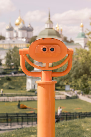 Stationary binoculars overlooking the city, close-up of metal binoculars on the background of the observation deck overlooking the church.の写真素材