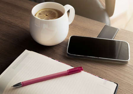 Work from home concept. Diary and phone for planning your daily agenda on your desk in your home...