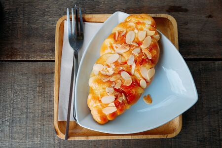 Bread sprinkled with almonds in a white dish
