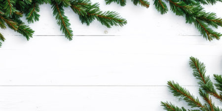 Christmas background. Fir branches on white wooden table. Top view with copy spaceの素材