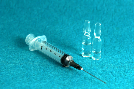 medical syringe with injection on blue background medicine health vaccine treatmentの写真素材