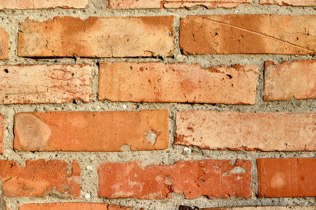wall of old weathered brick laid horizontally masonry texture backgroundの写真素材