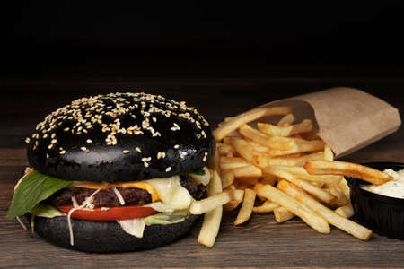 black burger on chalkboard with french friesの写真素材