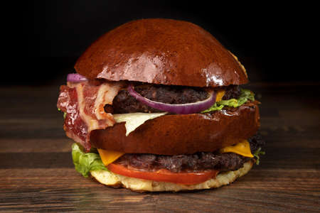 burger on dark background with french friesの写真素材