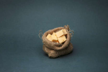 pieces of cheese in a small bag of burlap