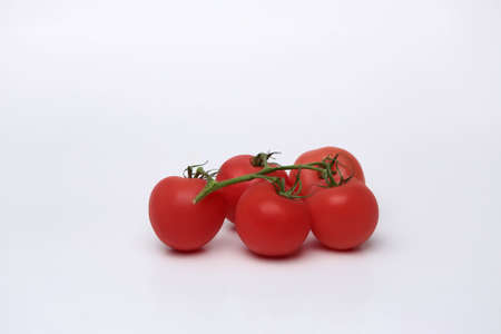 Cherry tomato bunch closeup isolated on white background.の写真素材