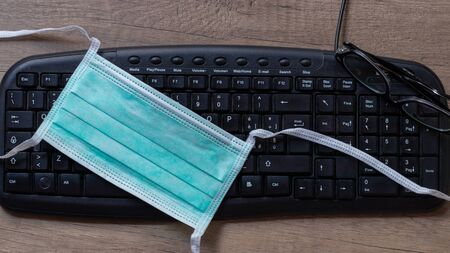 Coronavirus. Working from home with wearing protective mask. quarantine for coronavirus wearing protective mask. Working from homeの写真素材