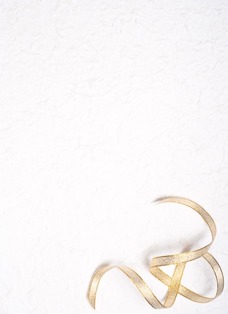 gold ribbon on mulberry paper backgroundの写真素材