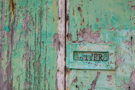 Green weathered wood door with letterboxの写真素材