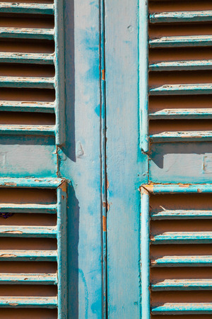 A cyan rusty window made with wood panelの写真素材