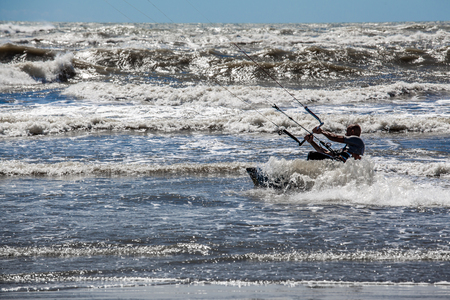 The silhouette of a surfer riding a wave on summertime in Italyのeditorial素材