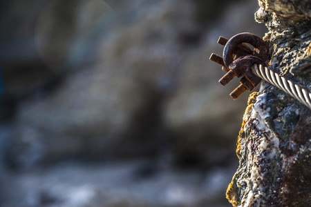 Rusty hook on sea rocks at french rivieraの写真素材