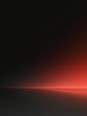 Red light emerging from black background abstract gradientの素材