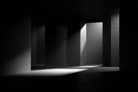Abstract dark concrete architecture with dramatic light and shadow play.の素材