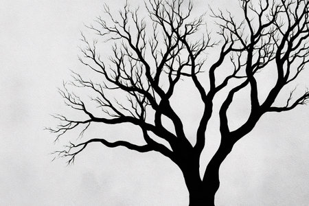 Stark silhouette of a leafless tree against a subtly textured background.の素材