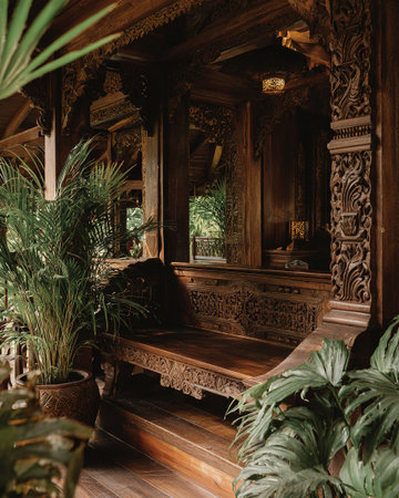 Detailed carved wooden interior with lush tropical plants, serene exotic ambiance.の素材