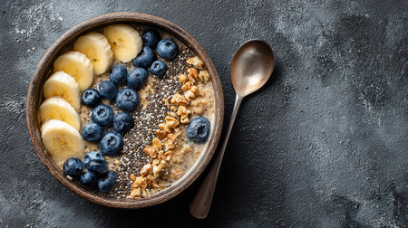 Nutritious breakfast bowl featuring oatmeal, fresh fruit, seeds, and granola.の素材