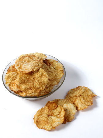 Sweet emping crackers food in a glass bowl isolated on white background.emping crackers are made...