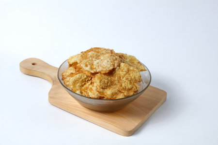 melinjo chips snack in a glass bowl on a wooden board