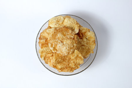 Sweet emping crackers food in a glass bowl isolated on white background.emping crackers are made...