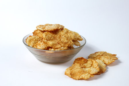 Sweet emping crackers food in a glass bowl isolated on white background.emping crackers are made...