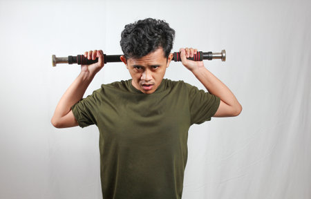 skinny asian man lifting light dumbbells isolated on white background