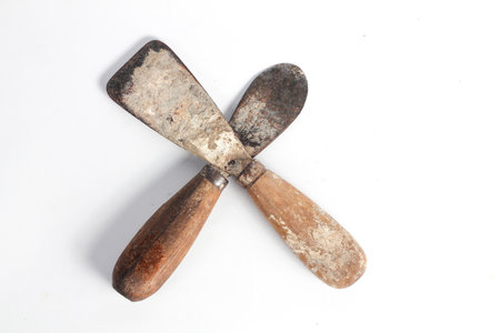 Rusty putty knife carpentry tool isolated on white background