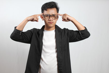Portrait of young Asian man with eyeglasses on white background