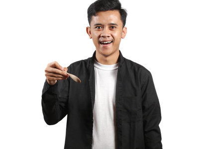 Portrait of young Asian man holding a wooden stick isolated on white background.