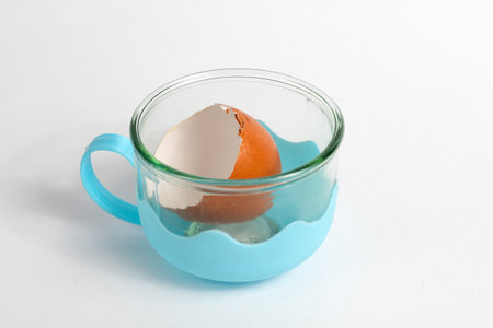 broken eggshell in a plastic cupの写真素材