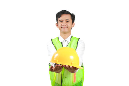 indian engineer wearing safety vest and holding helmet isolated on white background