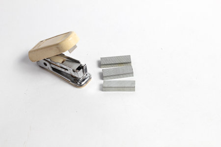 Stapler and staples isolated on white background. Top view.