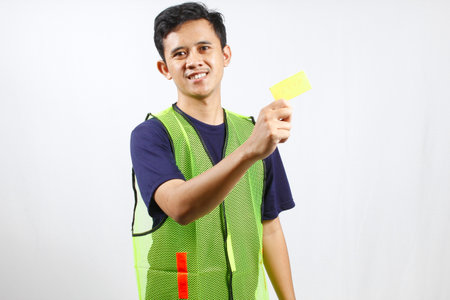 young man holding a yellow card in his hand on white background